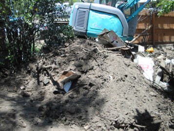 Excavator and heap of soil